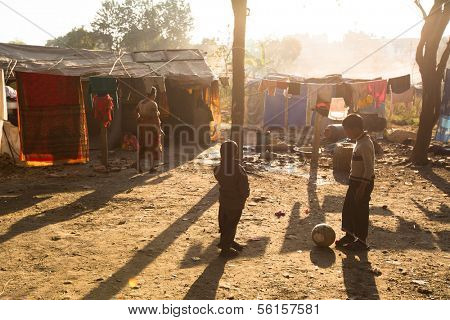 KATHMANDU, NEPAL - DEC 16: Unidentified poor people near their houses at slums in Tripureshwor district, Dec 16, 2013 in Kathmandu, Nepal. Caste of untouchables in Nepal, is about 7 % of population.