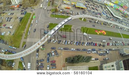 Crossroads of highways and railway with electric train near the telecentre, view from unmanned quadrocopter.