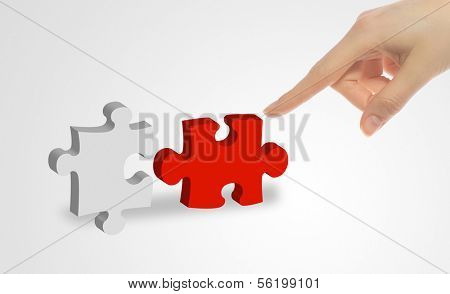 A person connecting to pieces of a puzzle.