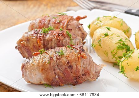 Grilled meat rolls wrapped in strips of bacon