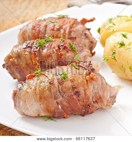 Grilled meat rolls wrapped in strips of bacon