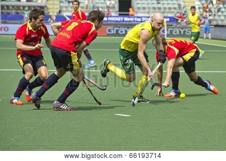 THE HAGUE, NETHERLANDS - JUNE 2: Glenn Turner (AUS) rushes through three Spanish defenders with the ball during the WOrld Cup Hockey match between Australia and Spain AUS beats SPA 3-0