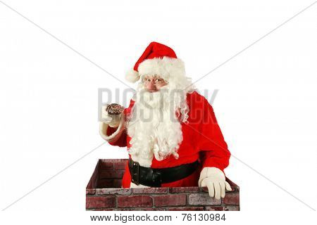 Santa Claus in a Chimney. Santa Claus exits a house through the chimney after delivering presents for all the good boys and girls with a donut that was left for him as a thank you gift. Santa Claus