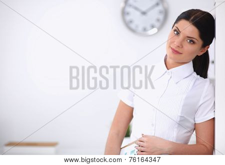 Attractive businesswoman with her arms crossed  standing in office