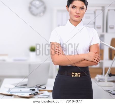 Attractive businesswoman with her arms crossed  standing in office
