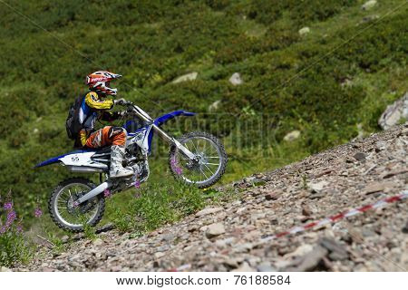 SOCHI, RUSSIA - AUGUST 16, 2014: Off-road motorcycle rider trains in summer mountains