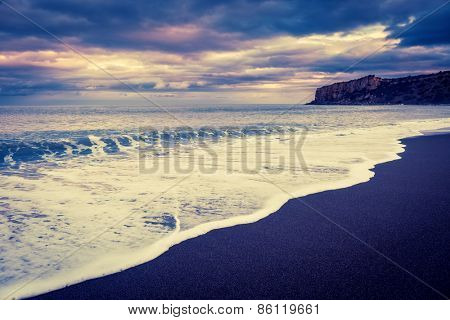 Fantastic view of beach Torre Conca (cape Rais Gerbi). Dramatic scene. Dark overcast sky. Location Cefalu. Tyrrhenian sea. Sicilia, Italy, Europe. Beauty world. Retro style filter. Instagram effect.
