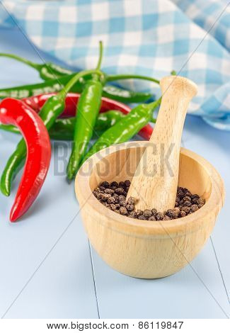 Black Pepper In Wooden Bowl And Chili Pepper