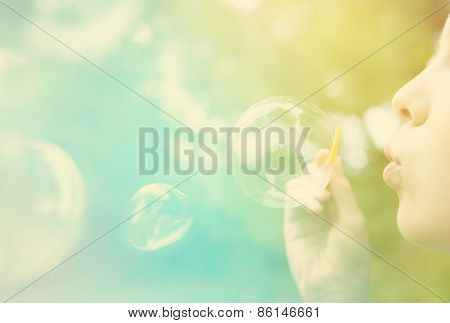 Child blowing bubbles.  Instagram effect
