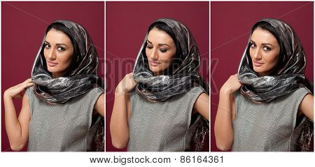 Attractive brunette woman in gray blouse and headscarf posing dramatic on purple background