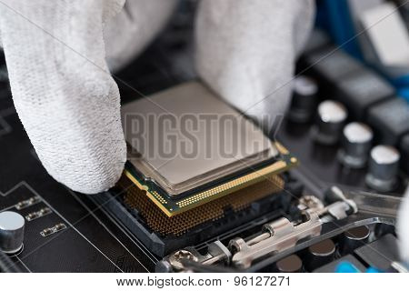 Person Installing Central Processor In Motherboard