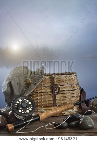 Fly rod with creel and equipment on wood table