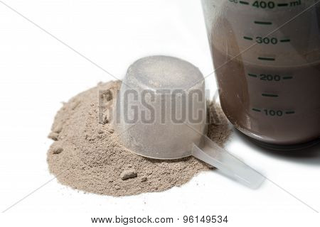 Chocolate Protein Shake With A Upturned Scoop Poured Protein Powder Isolated