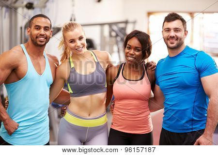 Happy group of gym buddies with arms around each other