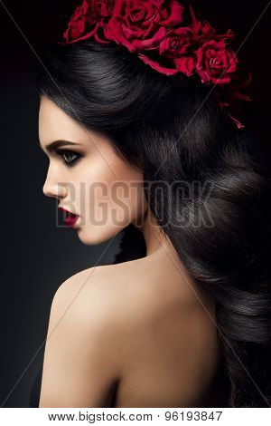 Beauty Fashion Model Girl Portrait with Roses Hairstyle. Red Lips.