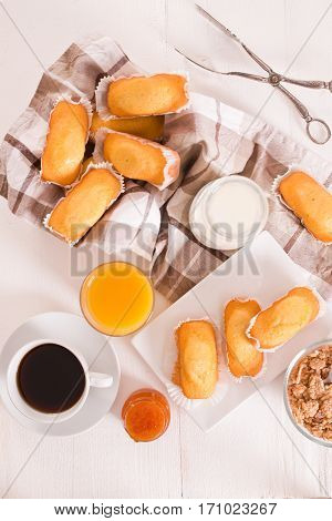 Breakfast with plumcake with jam on wooden table.