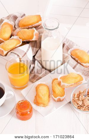 Breakfast with plumcake with jam on wooden table.