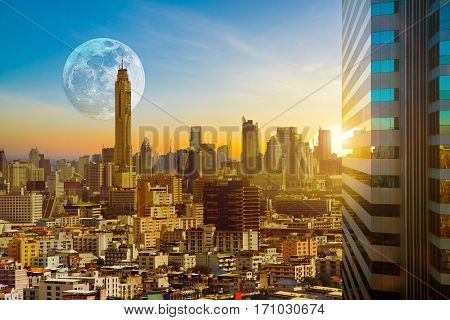 Bangkok cityscape on twilight evening backlit sunset with the super moon background Hyperreal Business city concept.