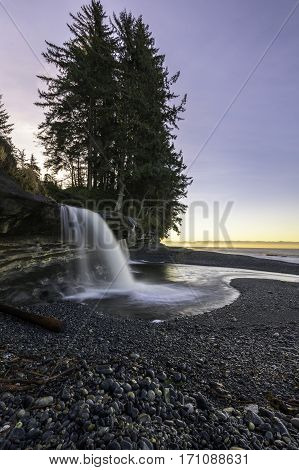 Morning light with a waterfall emptying into the Pacific Ocean Vancouver Island Canada