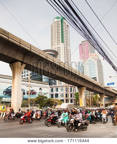 BANGKOK - JAN 24: Street with cars, motorcyclists and tuk tuks Jan 24, 2014 in Bangkok, Thailand. 