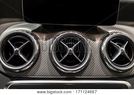 Luxury car dashboard with selective focus on air deflector