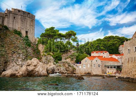 Dubrovnik West Harbor with Fort Lovrijenac and small houses with red roofs Dubrovnik Croatia