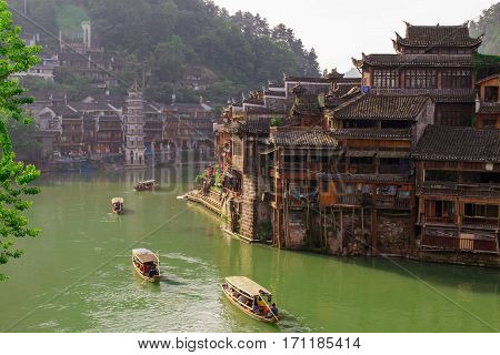 Photo of Ancient City Fenix in China. Historic Asian Scenery with Water Canals, Wooden Houses, Gondola Boats