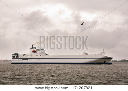 Cargo ship Ro-Ro in the Baltic Sea in bad weather. Image retro vintage filter effect.