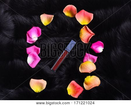 Murrey Lipstick Surrounded Rose Petals On Fur Background