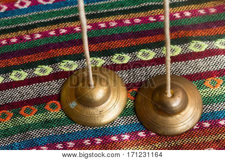 tingsha on a colorful wood table .