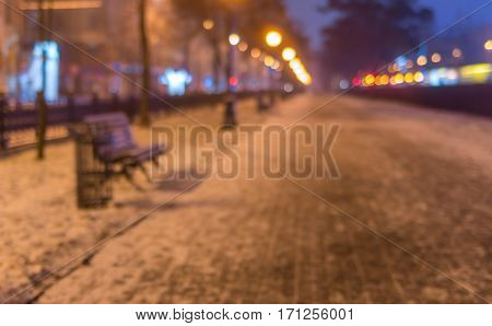 Blurry background - Empty illuminated street at winter night Dnepr city Ukraine