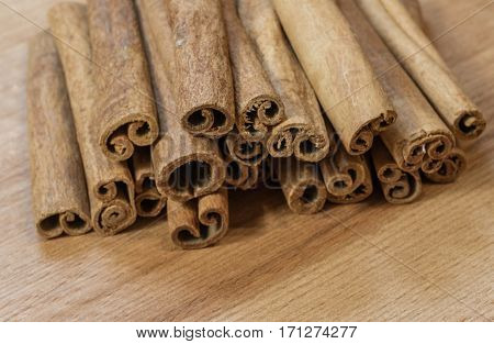 Fresh fragrance cinnamon sticks on brown wooden background