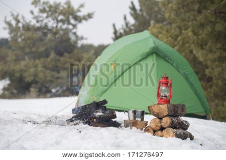 camping in the wood in the winter in a mountain tent