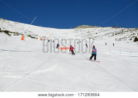 JASNA SLOVAKIA - JANUARY 23: The skiers snowborders and cableway in Jasna Low Tatras. It is the largest ski resort in Slovakia with 49 km of pistes on January 23 2017 in Jasna Slovakia