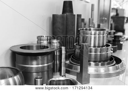 Industrial lathe tool and high precision cnc turning parts. high precision automotive machining mold and die part. CNC prosessed parts on table. Black and white.