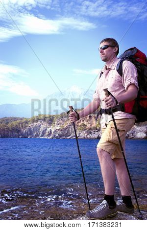 Summer hiking in the mountains with a backpack .
