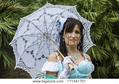 CAGLIARI, ITALY - June 1, 2014: Sunday at La Grande Jatte public gardens - Sardinia - portrait of a beautiful woman in Victorian costumes