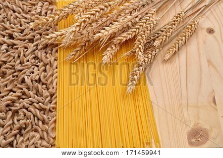 Wholemeal Pasta Fusilli From Organic Grain, Spaghetti From White Flour And Ears Of Wheat On A Rustic