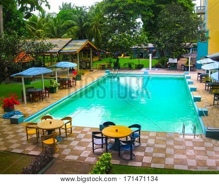 Negombo, Sri Lanka - April 29, 2009: The swimming pool at Camelot Beach Hotel at tropical Negombo, Sri Lanka on April 29, 2009