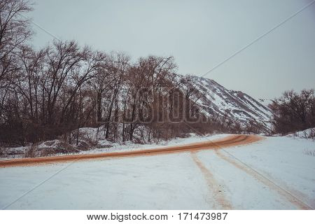 View on winter road that is red because of ore