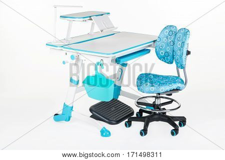 Blue chair school table blue basket desk lamp and black support under legs on the white isolated background.