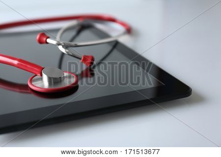 Stethoscope and tablet pc on white background