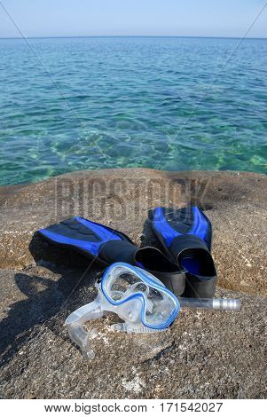 Masck and flippers on the rocks in tuscany
