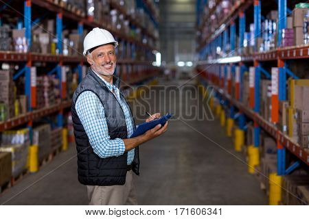 Portrait of warehouse worker checking the inventory in the warehouse