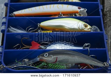 Several wobblers and spoonbait in the box with spinning baits