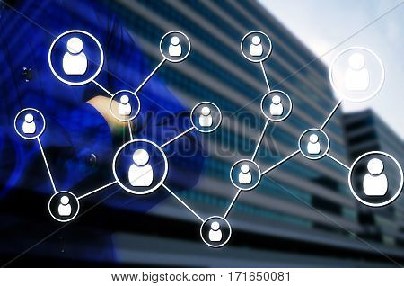 Double exposure of man arms crossed and icon social media connection concept with blurred background of office building, color tone effect.