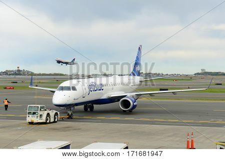 BOSTON - MAY. 6, 2015: Jetblue Airways Embraer 190 taxiing at Boston Logan International Airport, Boston, Massachusetts, USA.