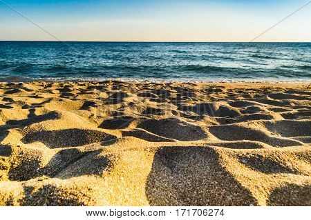 Pure yellow sand and sea on a deserted strip of beach