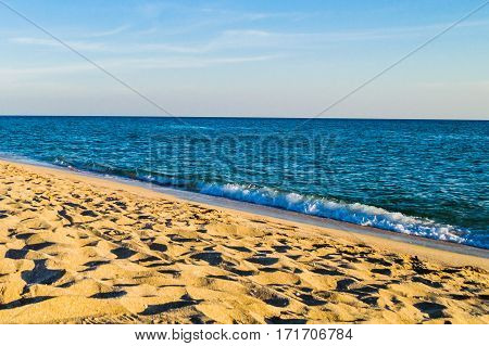 Deserted sandy beach. Sand sea and sky.