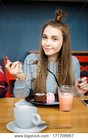 beatiful young woman eat desert in caffe.
